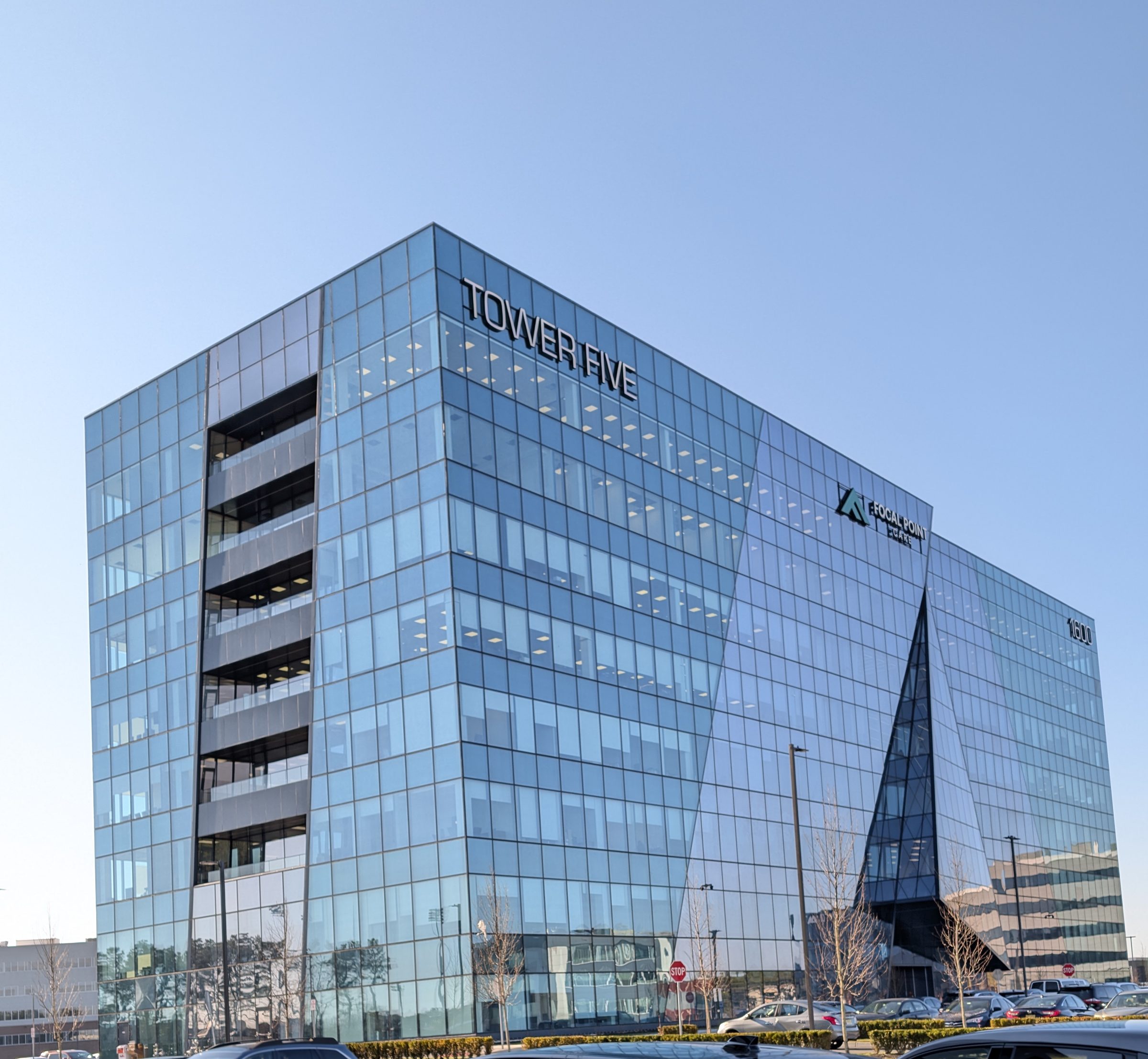 Tower Five, an eight story glass office tower at dusk